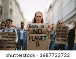 Small photo of Group of students on the streets demonstrating against climate change. People protesting for problem in ecology, environment, global warming, industrial influence, climate emergency.