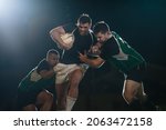 Small photo of Rugby player in possession of the ball and attempting to advance. Rugby players blocking and tackling opponent player to get the ball.