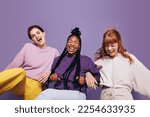Small photo of Multiethnic friends having a blast together in a studio. They are dancing and laughing, excited and having fun. In a lively scene full of energy, the girls show off their strong bond of friendship.