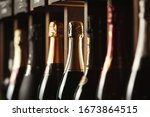 Small photo of Bottles of champagne on the shelf, close-up image of alcoholic beverages in the wine cellar. Close-up image.