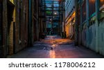 Small photo of Vancouver, British Columbia - Canada. Empty back alley on one of the streets of Vancouver, British Columbia. Canada. Chilly night just after a rain. Dangerous place to hang around.