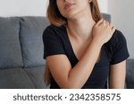 Small photo of Young woman with shoulder pain. Girl with an annoying stiff neck. Wryneck and postural pain concept.