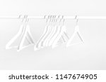many wooden white hangers on a... | Shutterstock . vector #1147674905