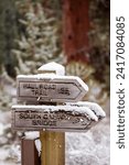 Small photo of Bend, Oregon US - January 6, 2024: Snow covered trail marker at South Canyon Reach of Deschutes River Trail in Bend, Oregon in winter. A popular hiking and running trail in Bend, Cascade Mountains.