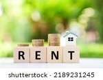 Real estate concept. House for rent. house model and stack of coin. Payment for temporary use of a property owned by another owner, tenant unwilling to pay full price, avoid burden of upkeep.