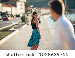 Small photo of Young attractive woman flirting with a man on the street.Flirty smiling woman looking back on a handsome man.Female attraction.Love at first sight.Meeting ex boyfriend