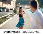 Small photo of Young attractive woman flirting with a man on the street.Flirty smiling woman looking back on a handsome man.Female attraction.Love at first sight.Meeting ex boyfriend