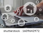 Small photo of Real estate concept. Houses on schema diagram. Person search, compare and select proper rent apartment in laptop.