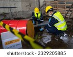 Small photo of Two officers wearing gas masks inspected the area of a chemical leak in an industrial warehouse to assess the damage. Technicians wearing gas masks inspect and assess the recovery of toxic spills.