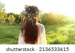 Girl in flower wreath on meadow ...
