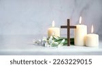 Small photo of Wooden cross, snowdrops flowers and candles on table, blurred abstract background. Religious church holiday. symbol of faith in God, Christianity Feast, Easter, Palm Sunday, Lent