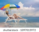 Small photo of woman relax comfortable sit on deck couch beach chair in water at middle part of sea, under multicolor beach gamp umbrella at lowest tide, enjoy holiday and weekend vacation in summer time