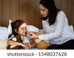 Small photo of family takes care of member sick in bedroom, taking liquid drug potion to stop fever, worry and keep close looking for effective future