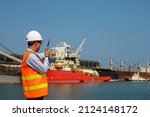 Small photo of Foreman, harbor master or port controller in takes control communication to the receivers in charge to ensure the appropriate jobs working in the same safety direction