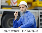 Small photo of man having a cigarette break