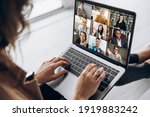 Back view of female employee communicate on video call with multiracial colleagues, woman worker conducts webcam group conference with business partners uses laptop and app