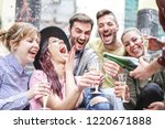 Group of happy friends doing party throwing confetti and drinking champagne outdoor - Young people having fun celebrating birthday together - Friendship and youth holidays lifestyle concept 