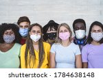 Group young people wearing face mask for preventing corona virus outbreak - Millennial friends with different race and culture portrait -  Coronavirus disease and youth multi ethnic concept 