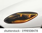 Car headlights. Luxury Headlights. Part of the white car. The headlights are on