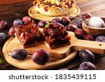 Small photo of Rustic plum cake on wooden background with plums around. Plum pie concept