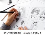 Manga style. The artist draws sketches of anime comics. Storyboard of characters on paper.