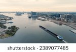 Small photo of Amsterdam, Netherlands - July 22, 2023: A barge loaded with coal passes near Amsterdam Central Station. Bay IJ (Amsterdam), Aerial View