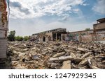 Earthquake or war aftermath or hurricane or other natural disaster, broken ruined abandoned buildings, pills of concrete garbage