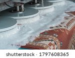 Small photo of Automatic washing and cleaning of carpets. Industrial line for washing carpets. Carpets chemical cleaning with professionally extraction method and disk machine. Early spring cleaning.