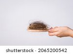Woman hand holding a comb with...