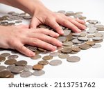 Small photo of Close-up of male hands clutching coins. The concept of wealth and affluence. Economy, money, business. Side view