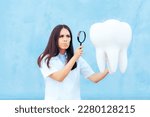 Small photo of Dentist Doctor Inspecting a Molar with Magnifying Glass. Funny dental specialist holding a magnifier for close inspection