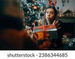 Small photo of Ungrateful Woman Refusing a Christmas Gift from a Friend Rude holiday party host rejecting presents from her guests