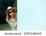 Small photo of Undercover Woman Wearing Hat and Sunglasses Spying. Jealous girlfriend in disguise stalking her boyfriend from afar