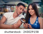 Happy Woman Testing Engagement Ring from Boyfriend with Magnifier - Young couple getting engaged in funny wedding proposal scene 