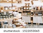 Zero waste shop interior details. Wooden shelves with different food goods and personal hygiene or cosmetics products in plastic free grocery store. Eco-friendly shopping at local small businesses