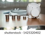 Small photo of coin & white piggy bank. money savings, cash deposit concept