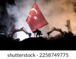 Small photo of Turkey Earthquake happend in February 2023. Decorative photo with Turkish flag, and ruined city buildings. Pray for Turkey. Selective focus