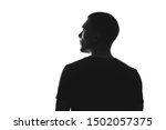 silhouette of man from behind on white background looks away