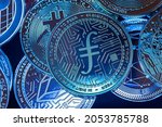Horizontal view of cryptocurrency tokens, including Filecoin, Bitcoin, dogecoin, and ethererum seen from above on a black background. High quality photo
