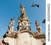 Small photo of Baroque rococo monument erected by the Catholic Society of St. John (Jan) Nepomuk in 1756. At the top of the monument is the statue of St. Mary.