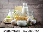 Small photo of Fresh dairy products, milk, cottage cheese, eggs, yogurt, sour cream and butter on wooden table