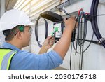 Small photo of Engineer or technician checking fiber optic cables in internet splitter box.Fiber to the home equipment. FTTH internet fiber optics cables and cabinet.