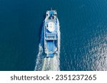 Small photo of Ferry boat crossing the sea, carrying cars and passengers, deck of a boat carrying vehicles. Aerial view