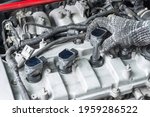 Small photo of Auto mechanic Installing modify ignition coil on car engine, Car Modify, Car maintenance service.
