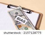 Small photo of the word Bias and and 100 dollar bills. Prejudice. Personal opinions. Preconception