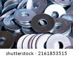 Small photo of steel metal washer is used in the connection and fastening of parts or structures in the production and construction areas together with bolts, screws, screws, studs and other cylindrical