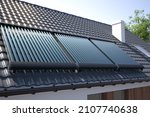 Solar panels, heater collectors on the roof, 3D illustration 