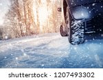 Car tires on winter road covered with snow. Snowy landscape with a vehicle
