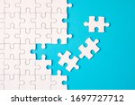 Many white jigsaw puzzle on blue background - idea solution concept.