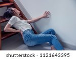 Small photo of Attractive asian woman accident fall off the stairs and backache Pain or broken backache in home health insurance concept
